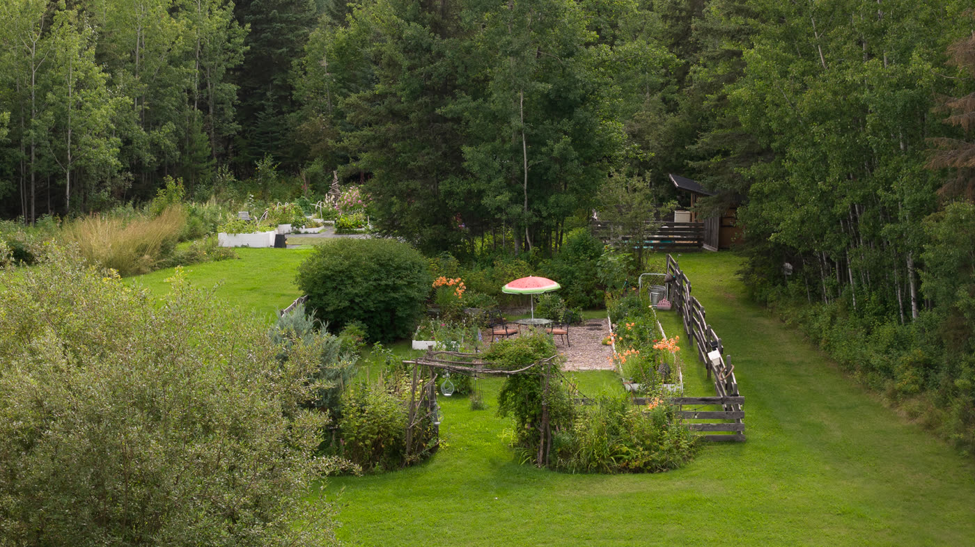 The property from the air, lawn and garden ringed by forest