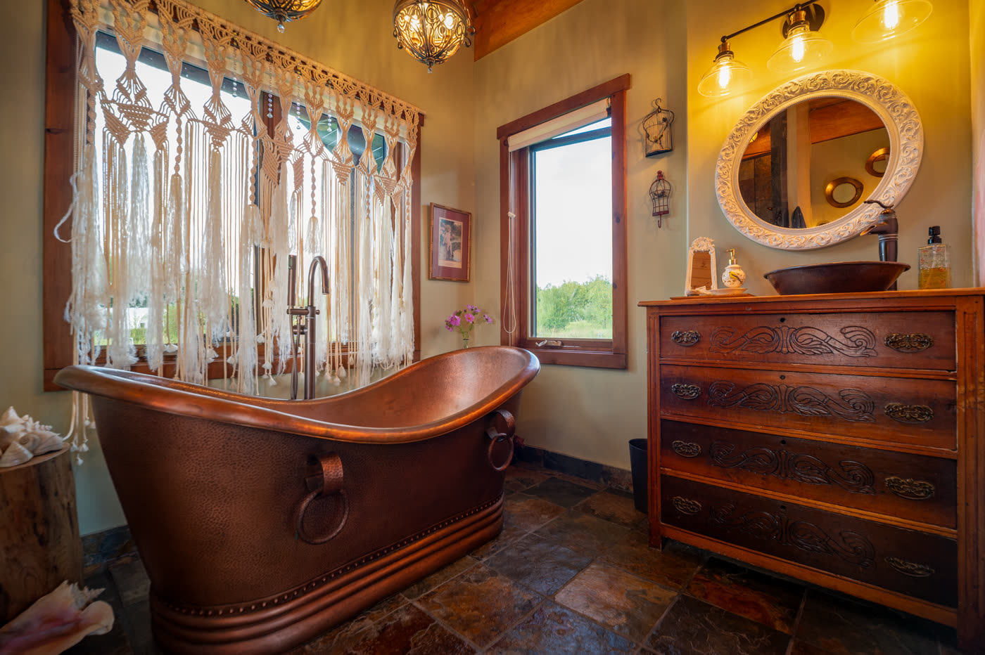 The copper soaking tub in the master bath, beside a window