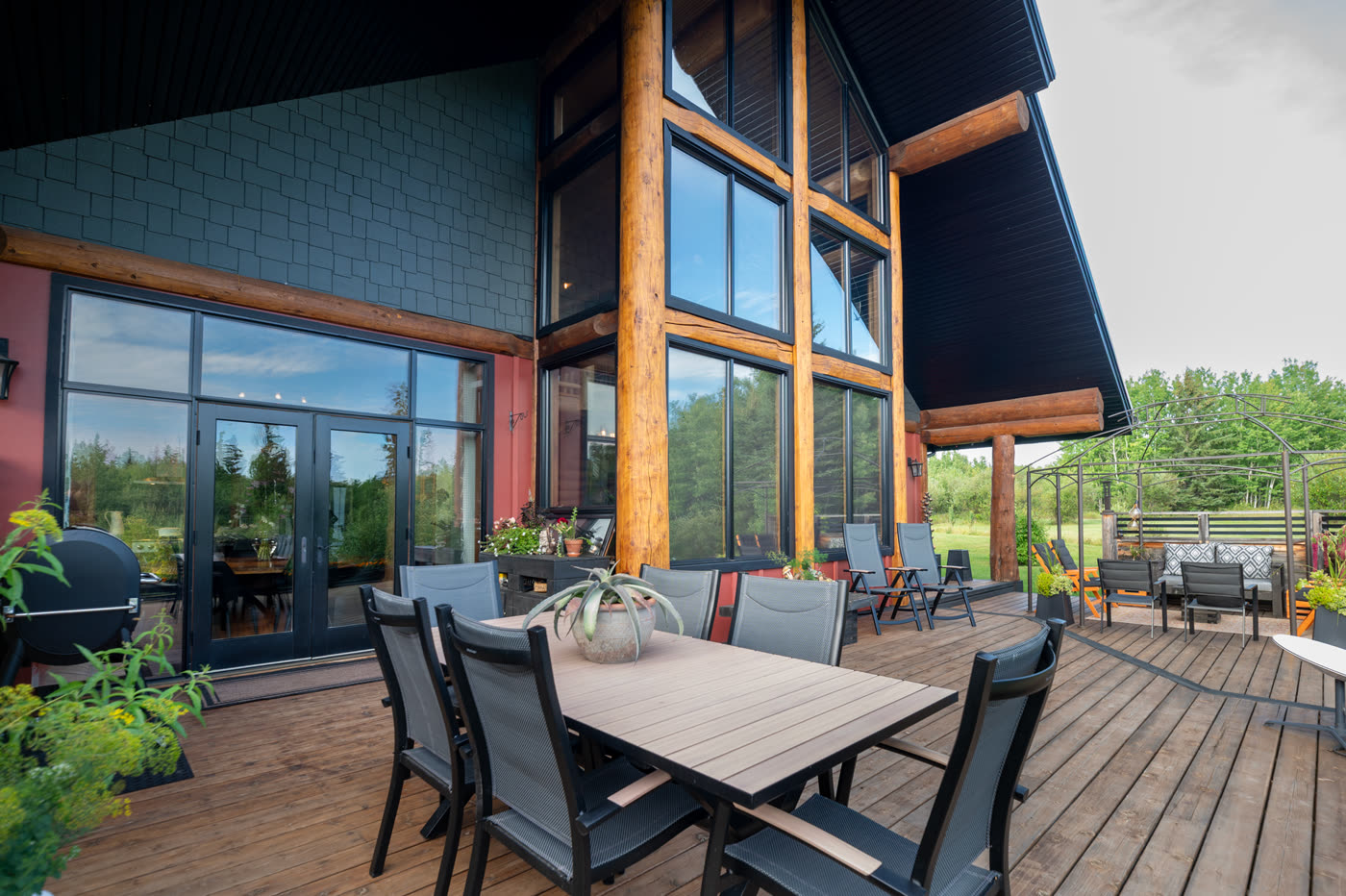 The lodge deck set for dinner, looking out over the grass