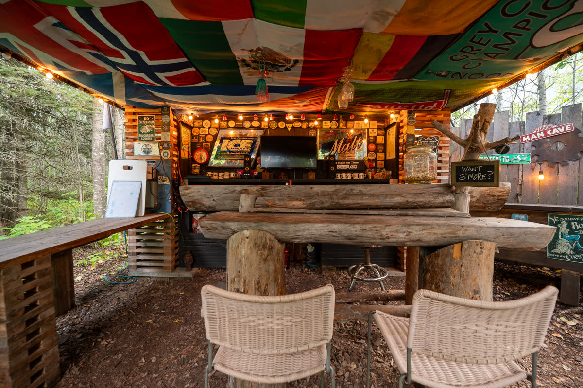 The outdoor bar, roofed with flags and hung with string lights